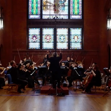 Smithsonian Academy Orchestra performing in a church